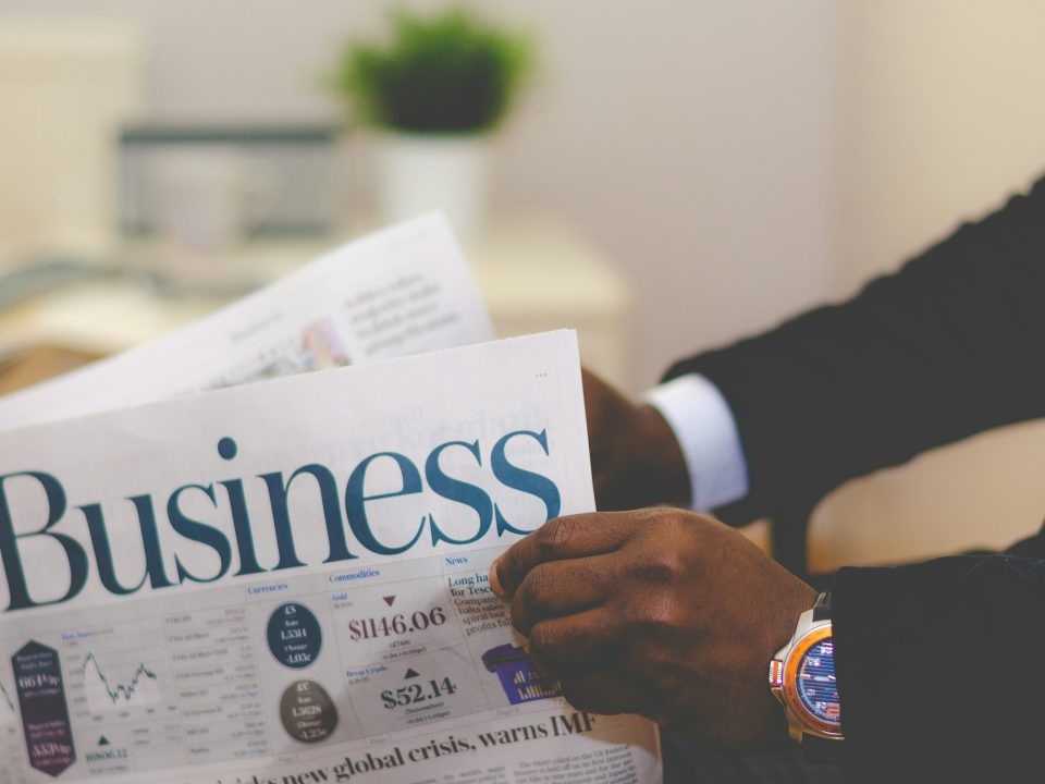 Business newspaper held by an investor